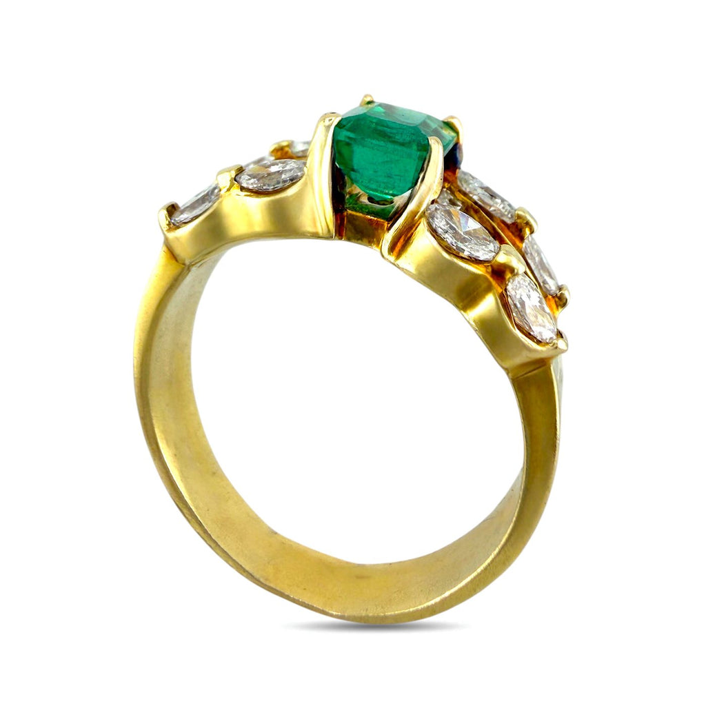 Yellow gold ring with green emerald center and white diamond accents in openwork setting