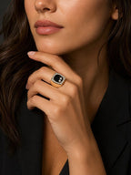 14K yellow gold diamond cocktail ring with square black center on a hand