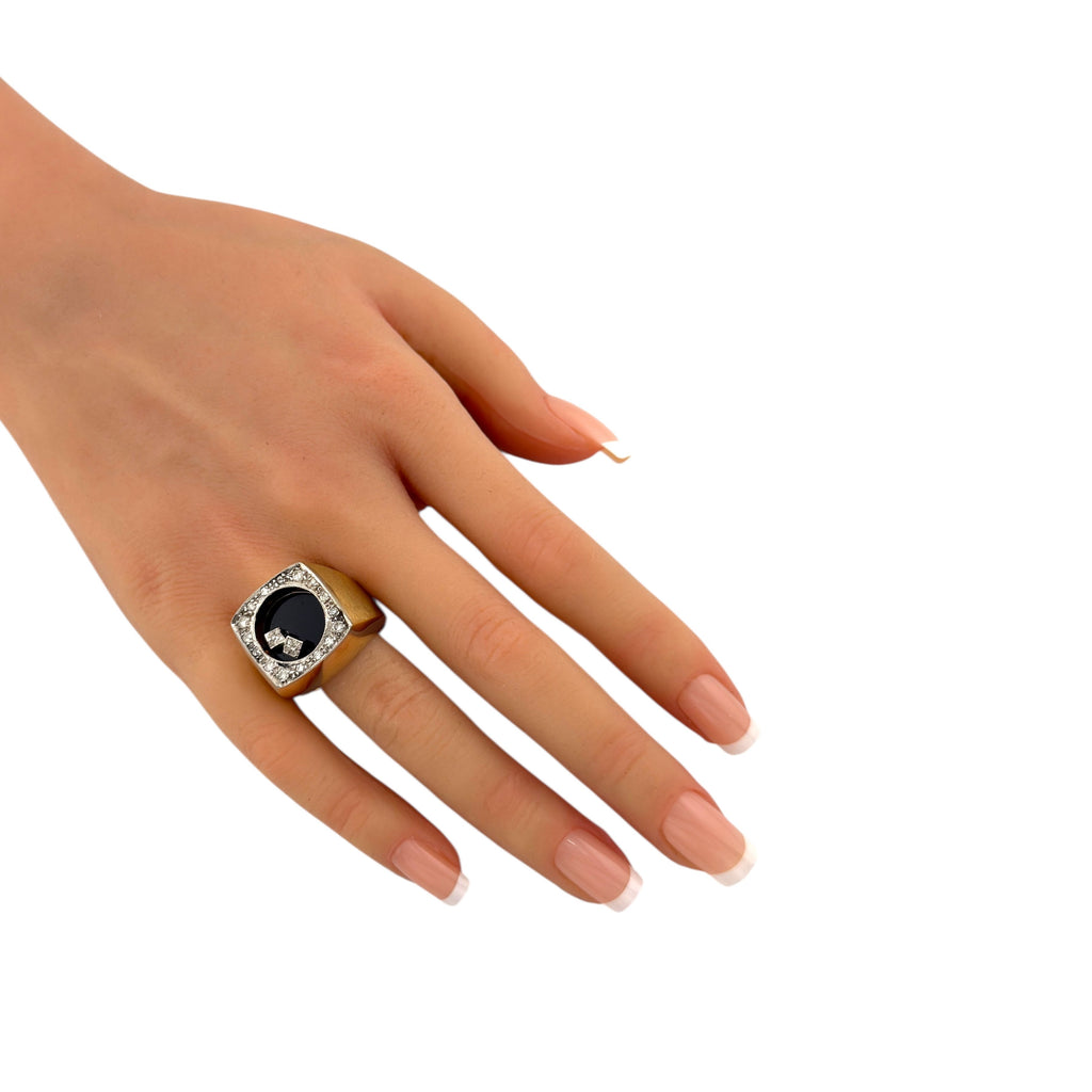 Yellow gold diamond halo cocktail ring with black center stone on hand