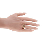 Yellow gold horsebit ring with oval clear gemstone, Gucci script and decorative gold bezel