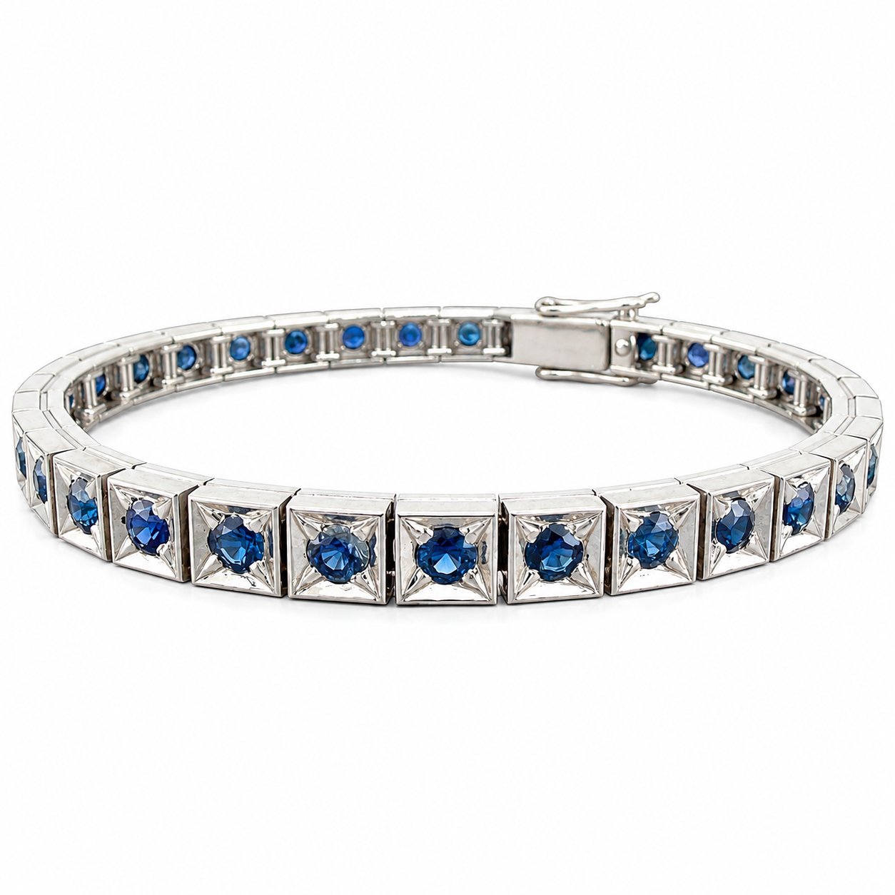 Platinum sapphire tennis bracelet with blue oval stones in square prong settings