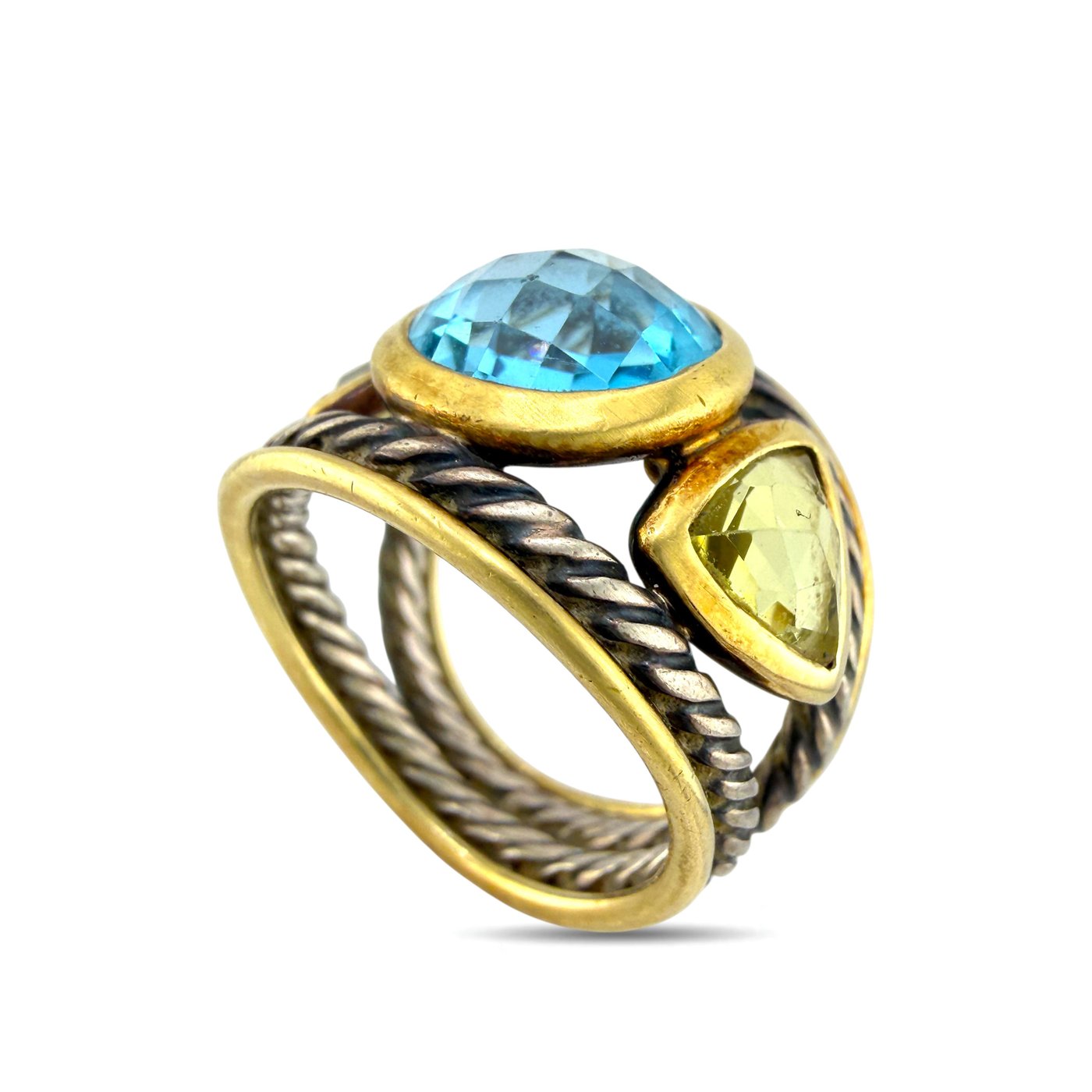 Gold and silver ring with oval blue topaz center stone and twisted braided bands