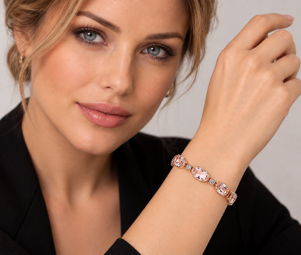 Rose gold bracelet with oval pink stones and diamond accents on a model’s wrist
