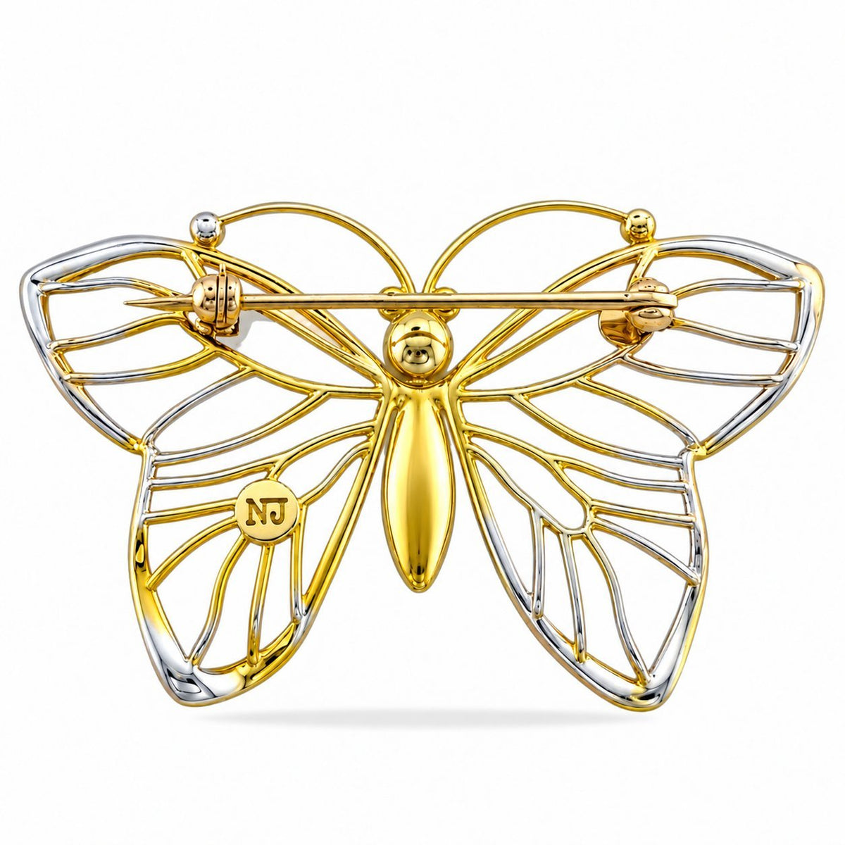 Back of the butterfly brooch showing its pin clasp and mixed gold-tone construction