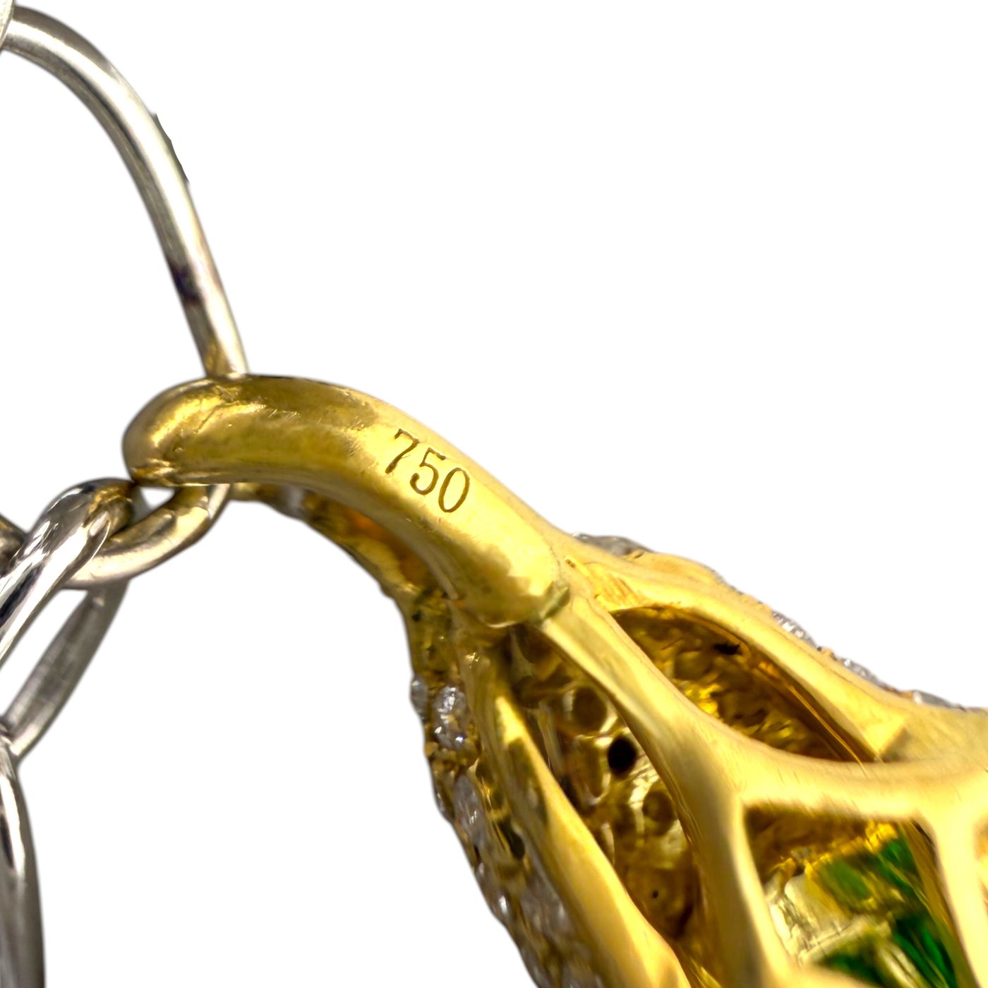 Gold bracelet link marked 750 with inset green stone on a silver chain