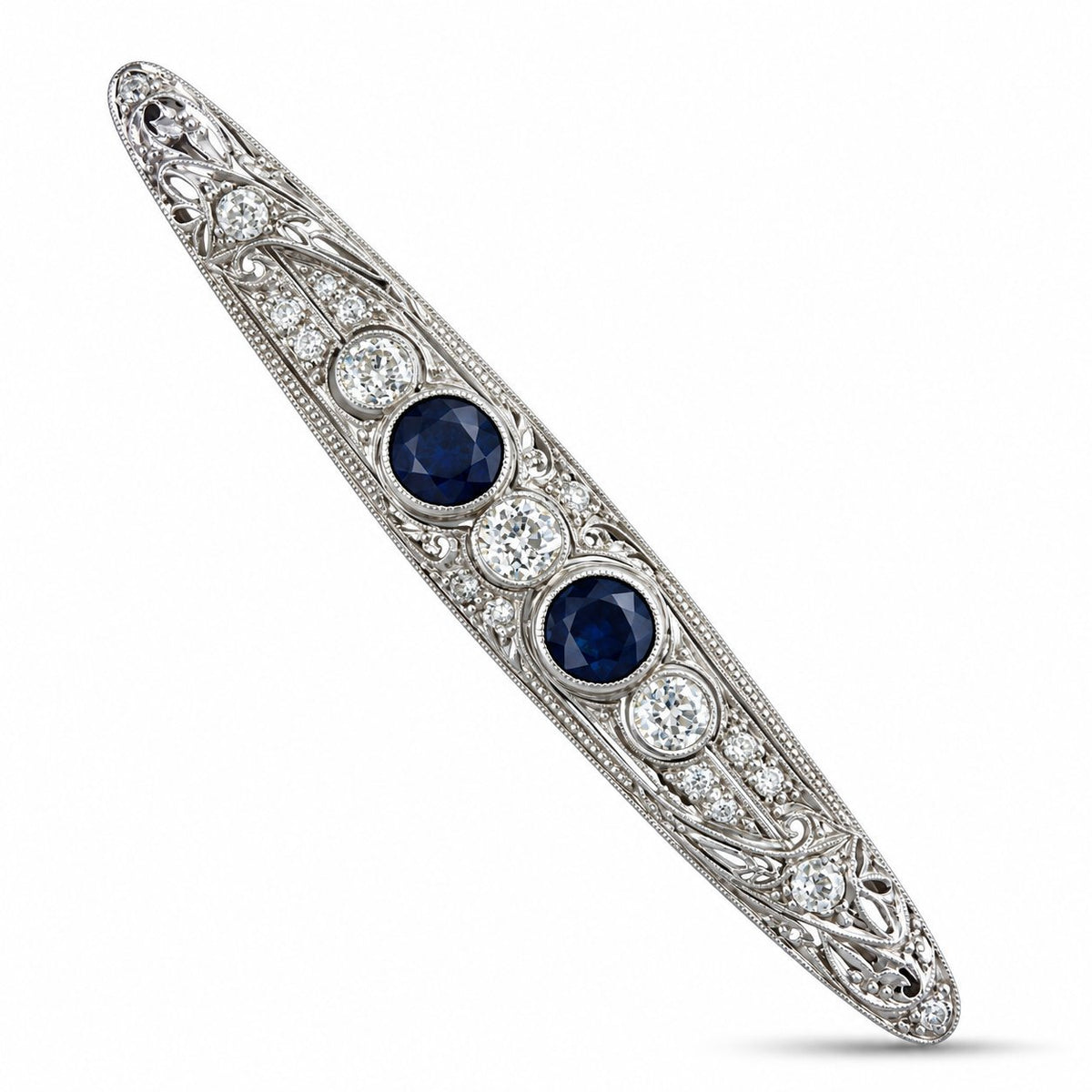 Art deco platinum brooch with two blue sapphires and diamond halo accents, bar pin