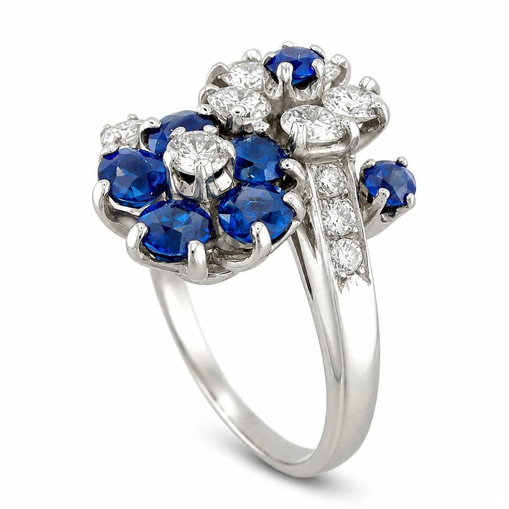 Platinum diamond-and-sapphire flower ring, top view showing oval blue stones and clear diamonds