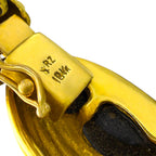 Close-up of the bracelet clasp stamped 18K gold