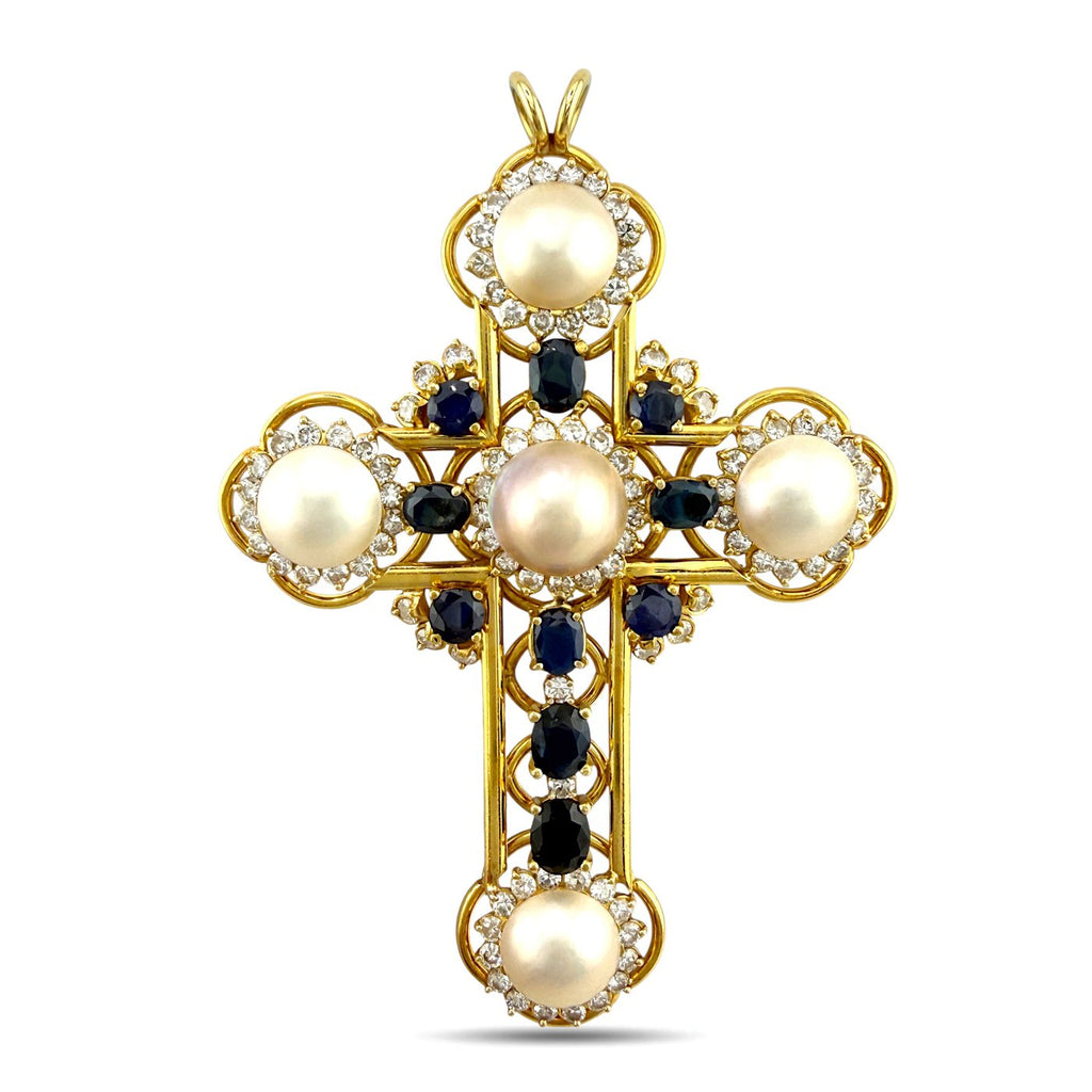 Gold cross pendant front view with large pearl, dark blue sapphires, and diamond halo