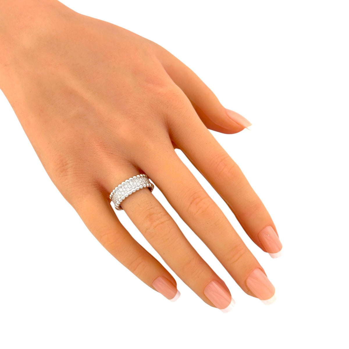 Van Cleef & Arpels Perlee diamond band ring worn on a finger, close view
