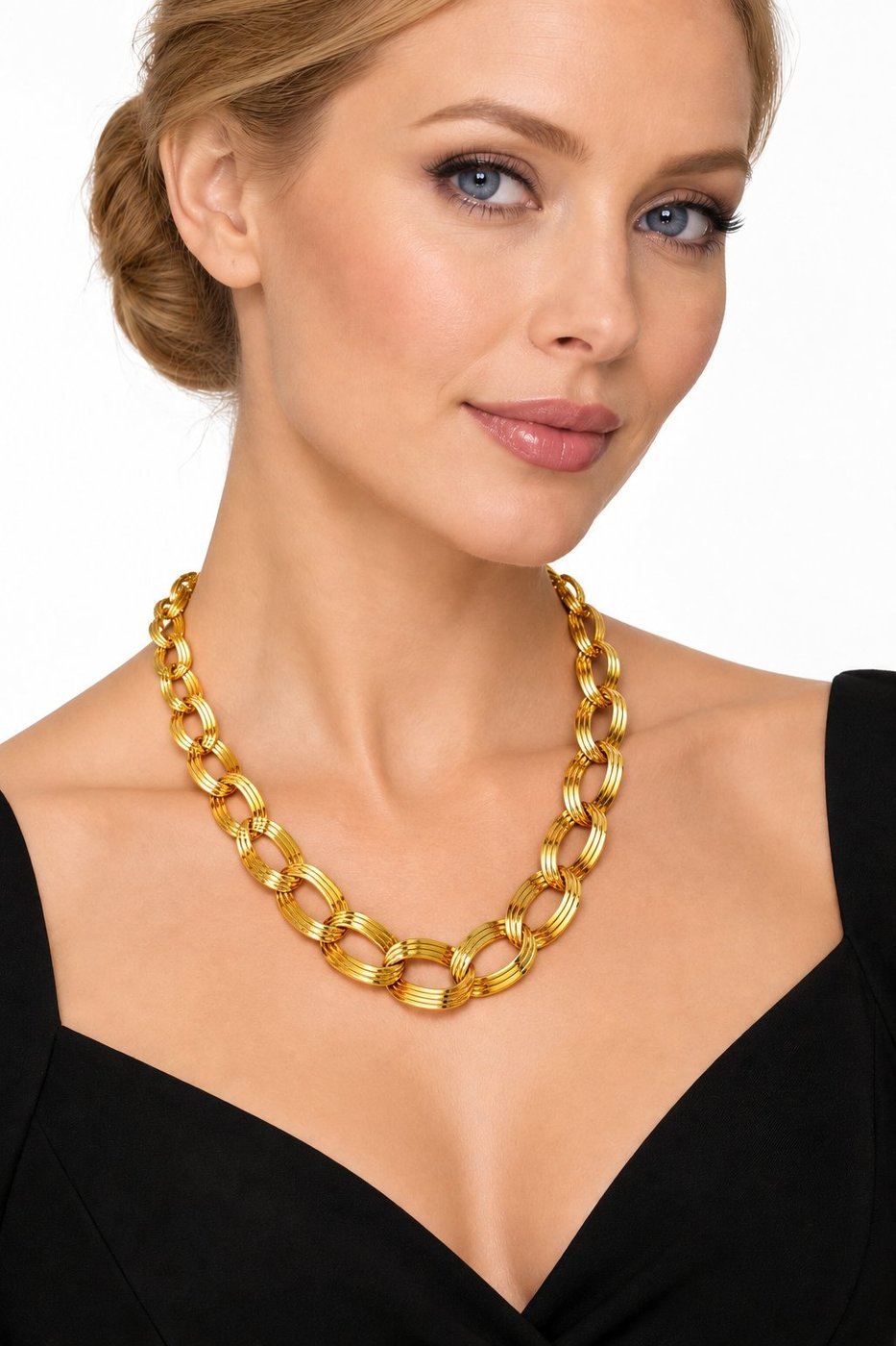 Gold tone circle link necklace worn with a V-neck top; rounded link segments