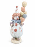 Porcelain clown figurine holding stacked pastel balloons, blue ruffled collar and star dress