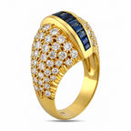 18K yellow gold ring with blue sapphire channel and dense round diamond cluster