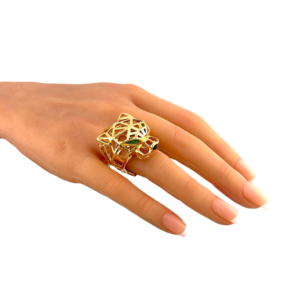 18K yellow gold panther ring on finger with green stone and open lattice setting