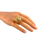 18K yellow gold panther ring on finger with green stone and open lattice setting