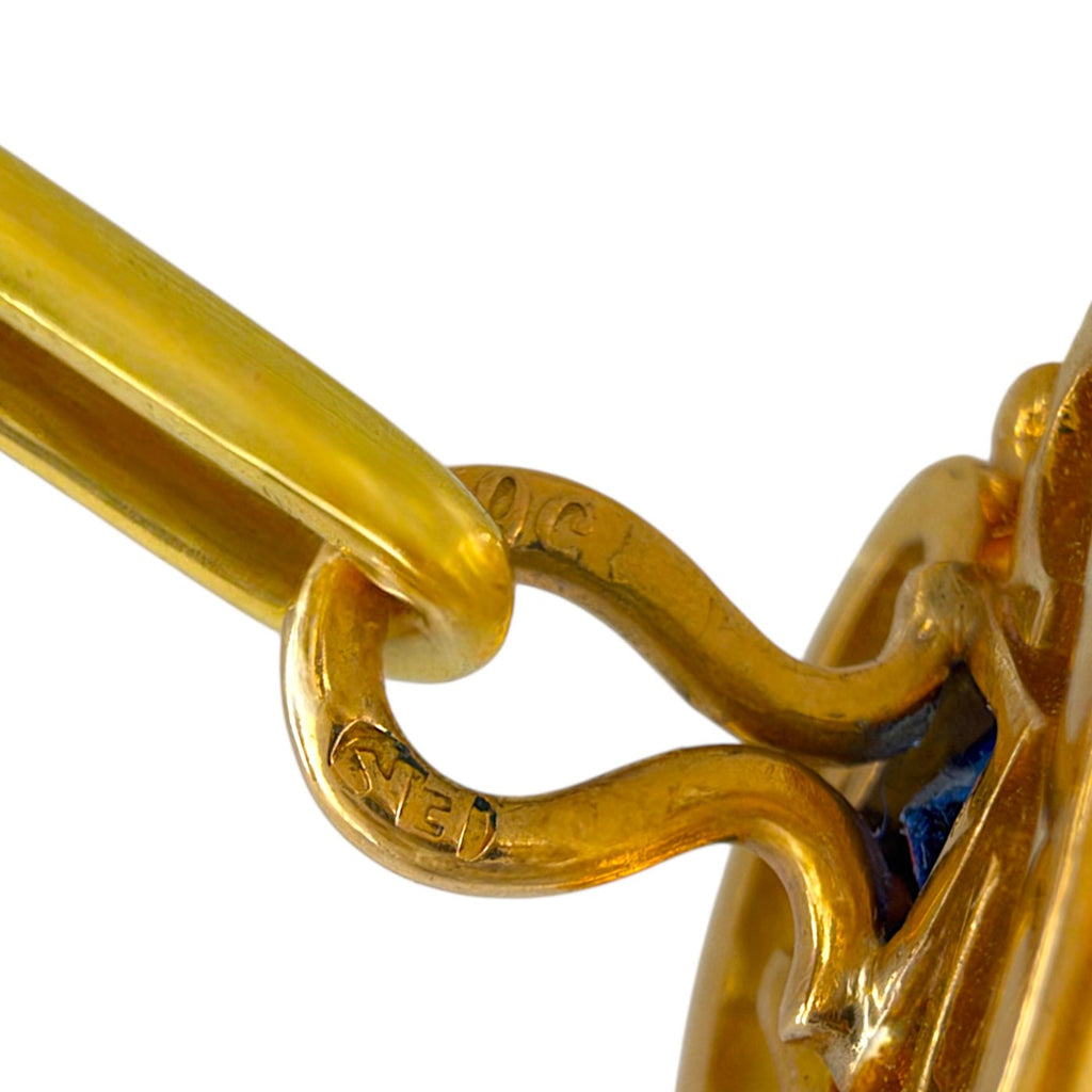 Close-up of the gold cufflink hinge and connecting bar