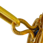Close-up of the gold cufflink hinge and connecting bar