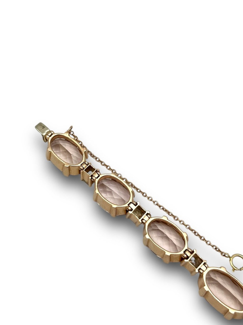 Rose gold bracelet close-up with oval bezel-set stones and gold link details