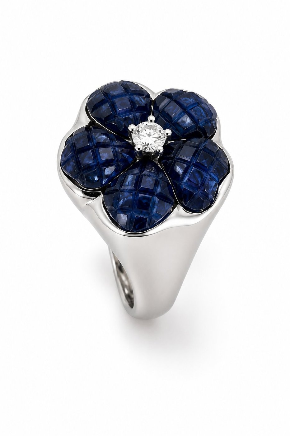 Three-quarter view of blue sapphire flower ring with round diamond center in white gold