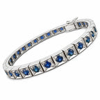 Platinum sapphire tennis bracelet angled view with blue stones and small round blue accents