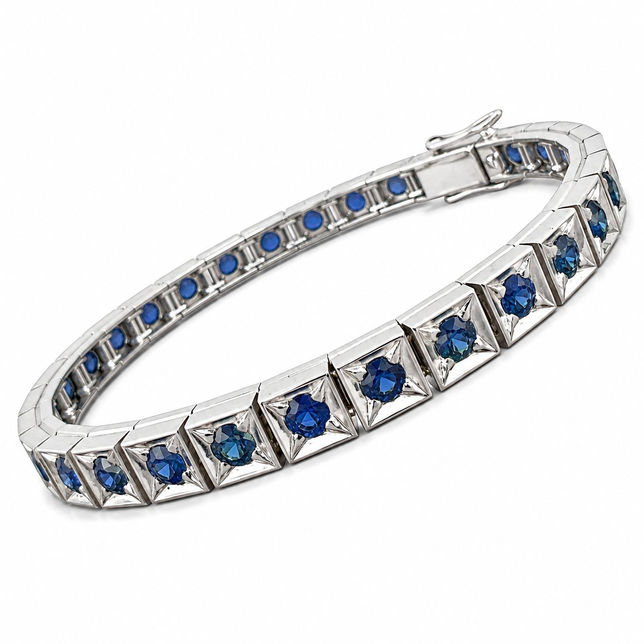 Platinum sapphire tennis bracelet angled view with blue stones and small round blue accents