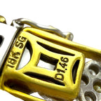 Gold bracelet clasp close-up with engraved markings and surrounding diamond-set links