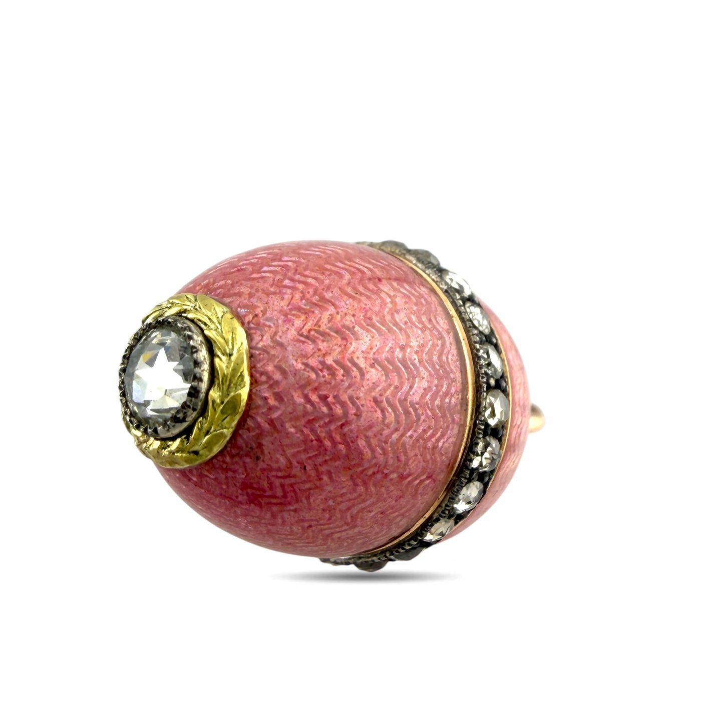 Side view of pink enamel egg pendant with round clear stone, gold details, and stone rim.