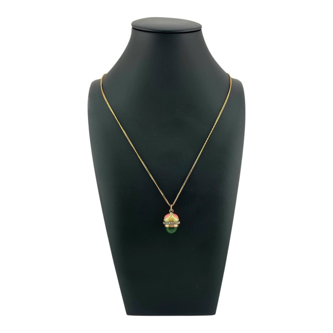 Jeweled egg pendant necklace with multicolor enamel and diamond accents on a gold chain.