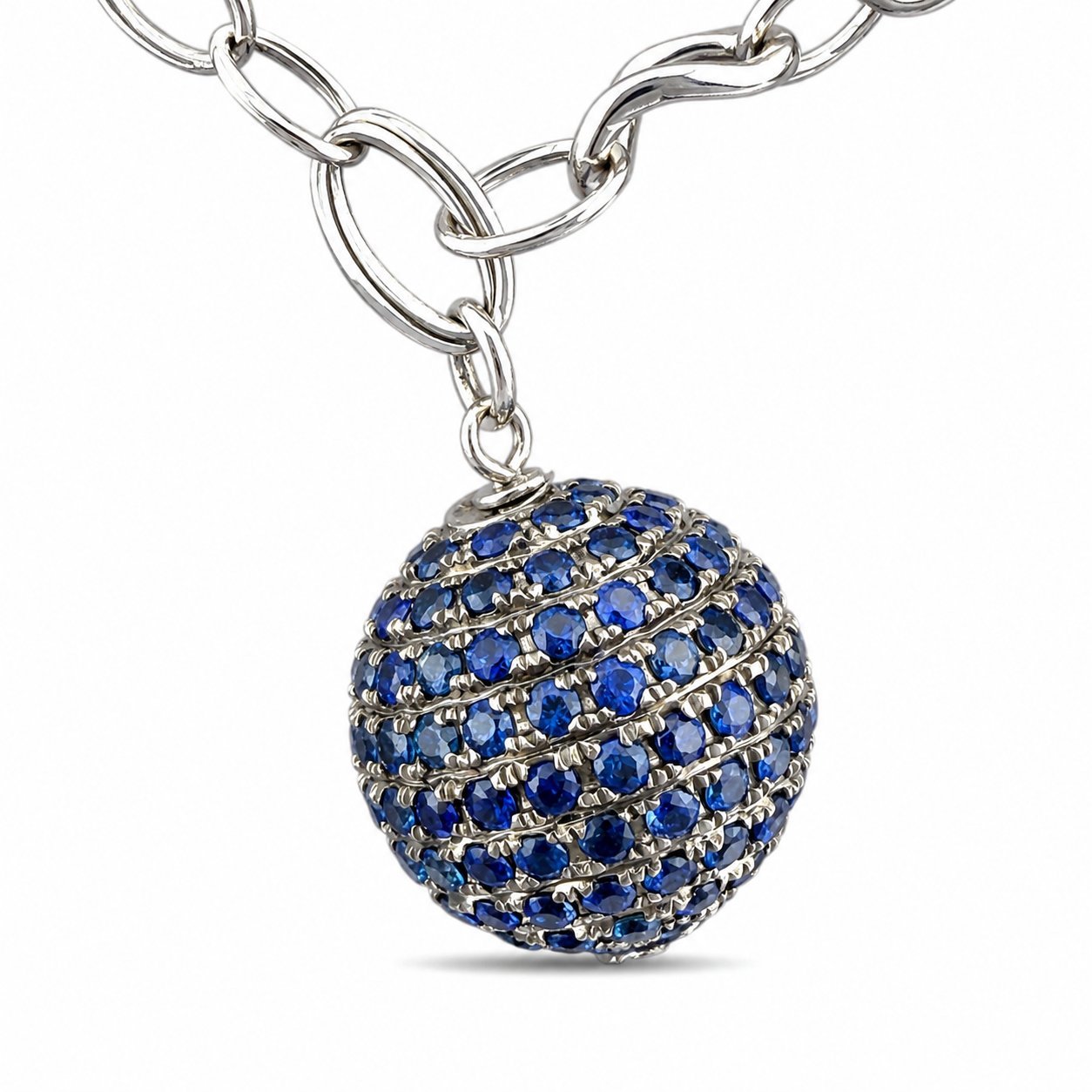 Blue jeweled ball charm on a silver chain bracelet with sapphire-toned stones