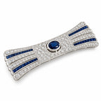 Diamond and sapphire bar brooch with blue oval center stone, arched frame and striped bands