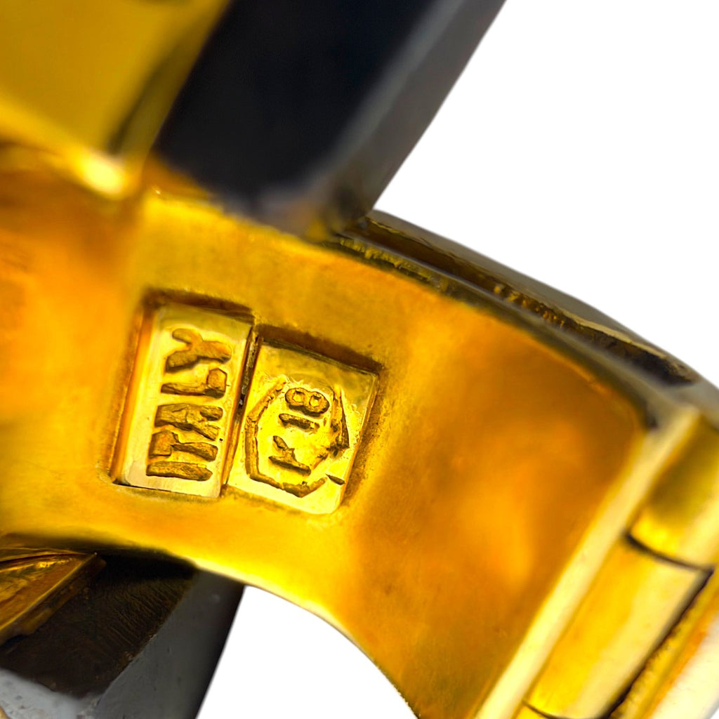 Close-up of 18K gold hallmark on clasp with black wood link