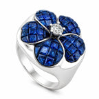 18K white gold ring with a blue sapphire four-petal flower and a round diamond center