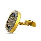 Faberge 14K yellow gold cufflink with diamond border, ruby center, and blue enamel
