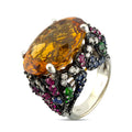 Cocktail ring with large orange citrine center and multicolor gemstones on silver setting
