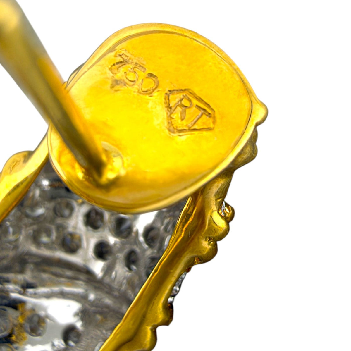 Close-up of the gold earring back with a stamped hallmark and diamond settings