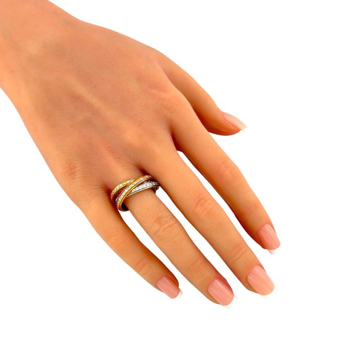 Tri-color diamond ring worn on a hand, with three interlocking gold bands