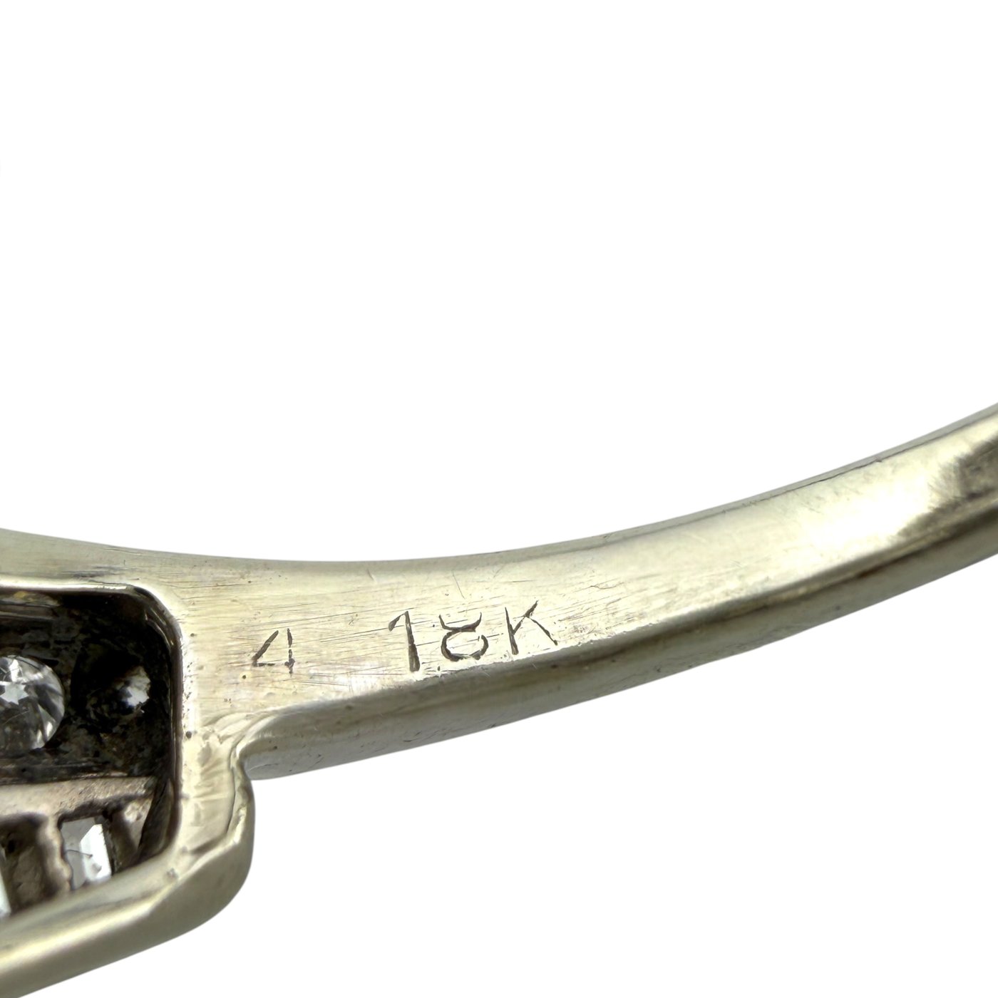 Close-up of 18K gold ring hallmark and band engravings