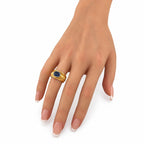 14K yellow gold sapphire ring on fingers with oval blue center stone