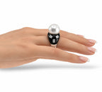 White gold ring with pearl top and black onyx band, emerald-cut diamond squares