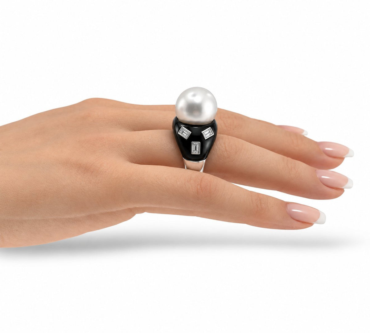 White gold ring with pearl top and black onyx band, emerald-cut diamond squares