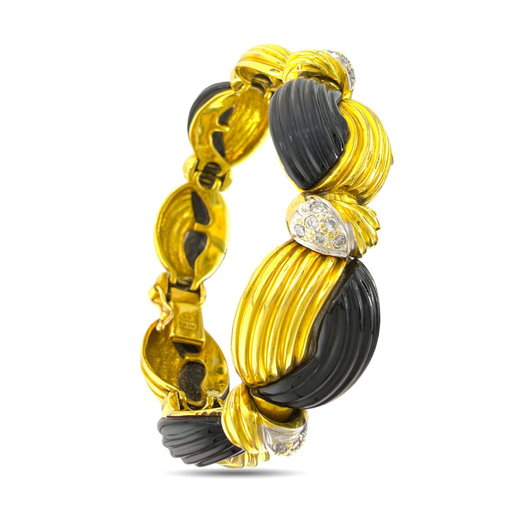 Side view of the bracelet's ribbed gold and black onyx links with diamond accents