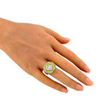 Square and round diamond ring worn on a finger, showing its raised gold setting