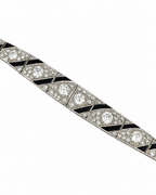 Art Deco 18K white gold diamond bracelet with prong-set round stones and black enamel