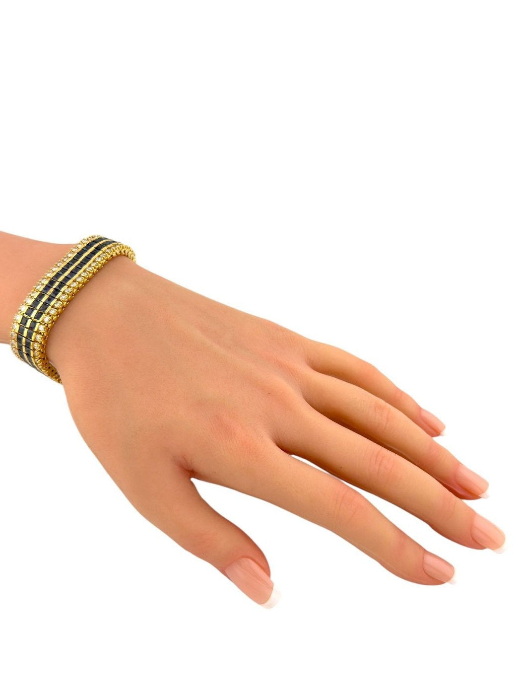 Yellow gold bracelet with blue sapphire checker panels and diamond rows, worn on wrist.