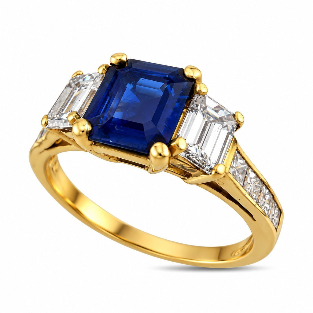 18K yellow gold ring with blue sapphire center and side baguette diamonds