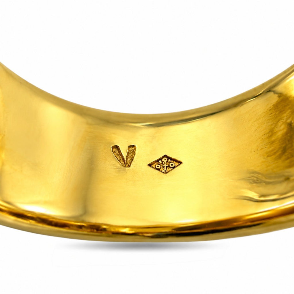 Close-up of inside gold band with stamped marks on sapphire ring