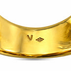Close-up of inside gold band with stamped marks on sapphire ring