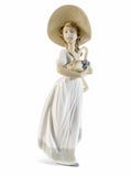 LLADRO Nao porcelain figurine in white dress holding a small black bird