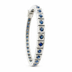 Platinum sapphire tennis bracelet side view with faceted blue stones in bezel settings