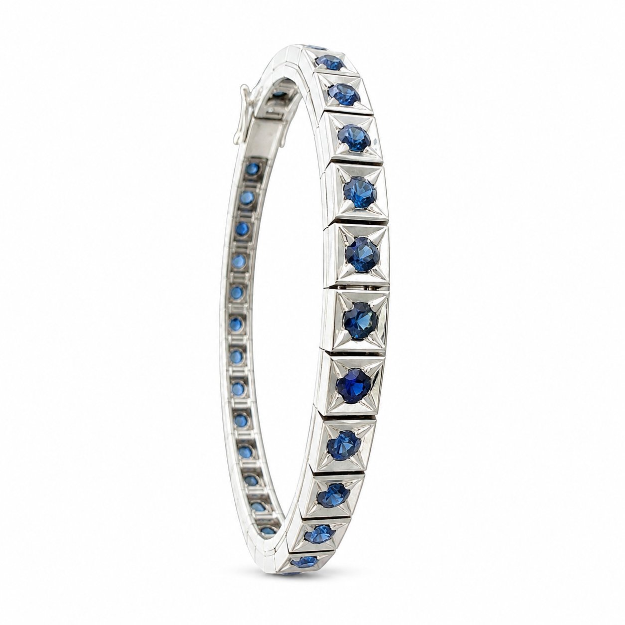 Platinum sapphire tennis bracelet side view with faceted blue stones in bezel settings